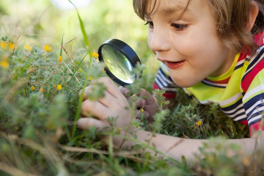 Young-boy-looking-through-magnifying-glass
