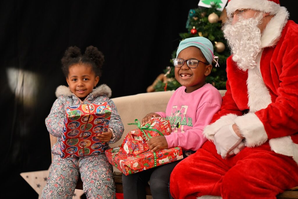 Christmas giving event at Lineham Farm young girls with gifts